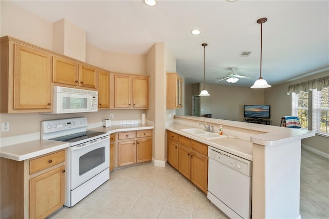 kitchen with visible vents, light brown cabinets, a sink, white appliances, and a peninsula