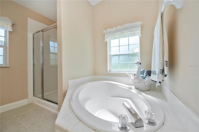 full bath with baseboards, a garden tub, a shower stall, and tile patterned flooring