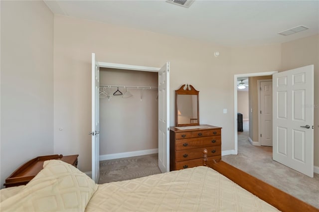 carpeted bedroom featuring visible vents, a closet, and baseboards