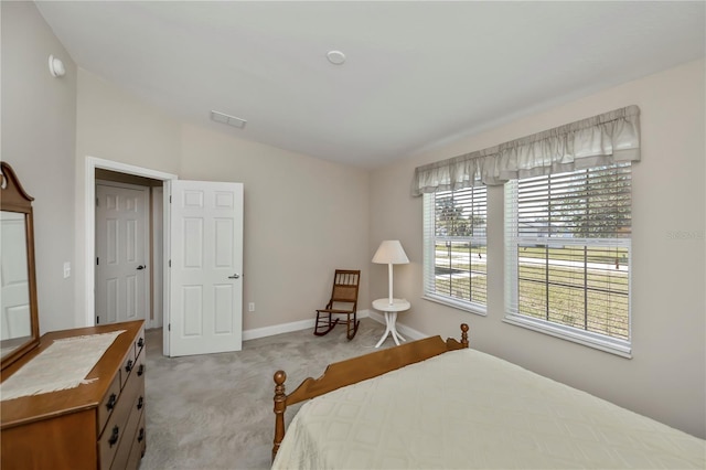 carpeted bedroom with visible vents, baseboards, and vaulted ceiling