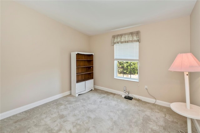 carpeted empty room with baseboards