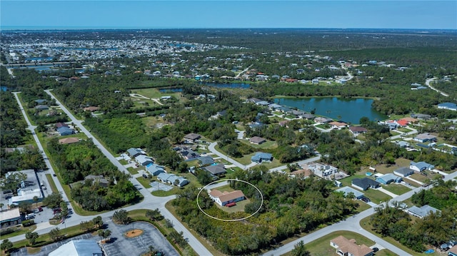 drone / aerial view featuring a residential view and a water view