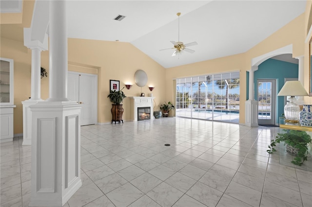 unfurnished living room featuring visible vents, a ceiling fan, a glass covered fireplace, lofted ceiling, and ornate columns