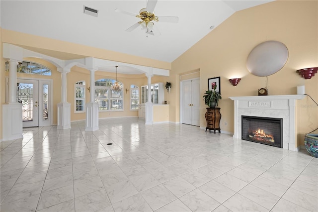 unfurnished living room featuring a ceiling fan, visible vents, decorative columns, a high end fireplace, and marble finish floor