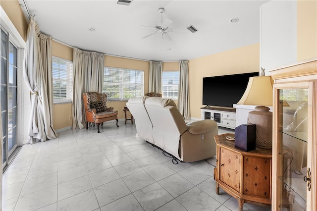 living area with visible vents and ceiling fan