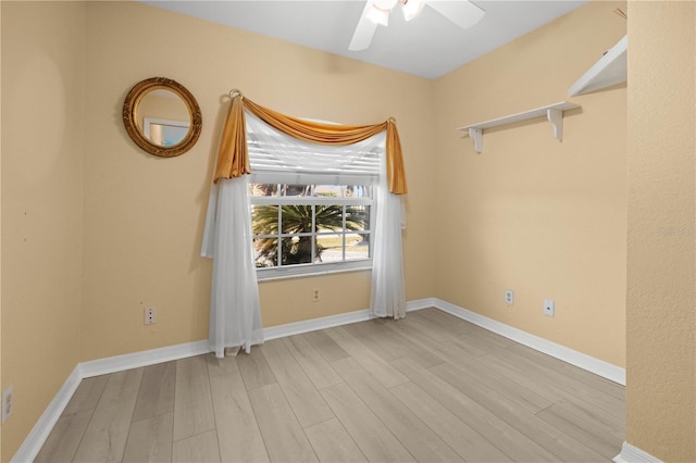 unfurnished room with ceiling fan, baseboards, and wood finished floors