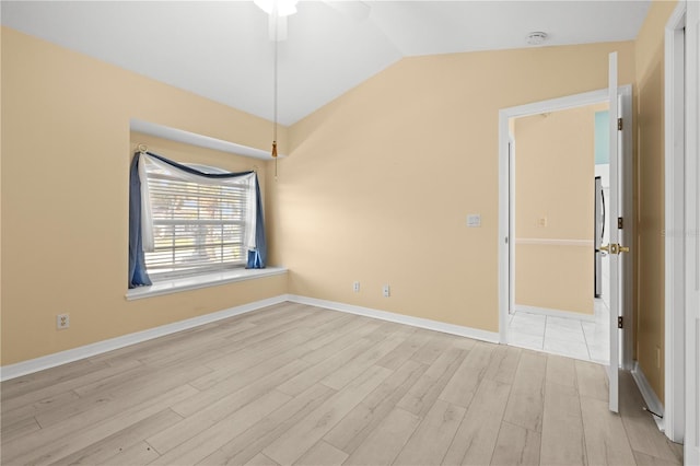 unfurnished room featuring baseboards, lofted ceiling, and light wood-style flooring