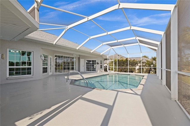 outdoor pool with a patio area and a lanai