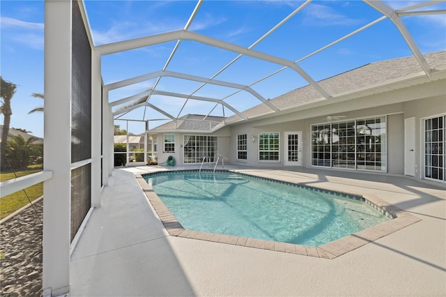 outdoor pool with a patio, a ceiling fan, and a lanai