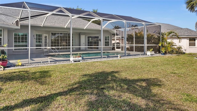 rear view of house with a patio area, stucco siding, glass enclosure, and a yard