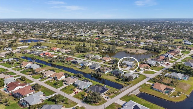 birds eye view of property with a residential view and a water view