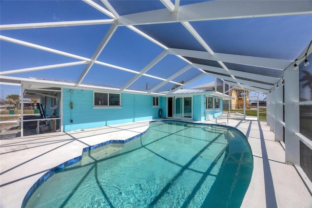 pool with glass enclosure and a patio