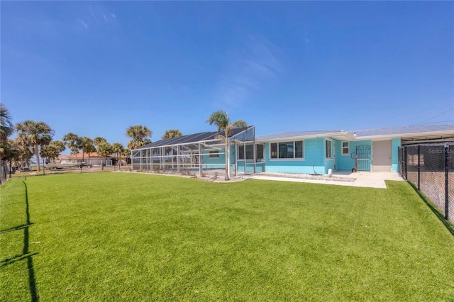 view of yard featuring an outdoor pool, a lanai, and fence