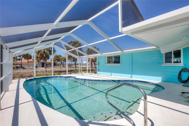 pool with glass enclosure and a patio