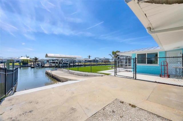 view of patio / terrace featuring a boat dock, a gate, and fence