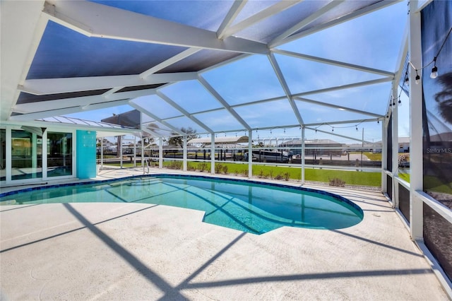 outdoor pool with a lanai and a patio area