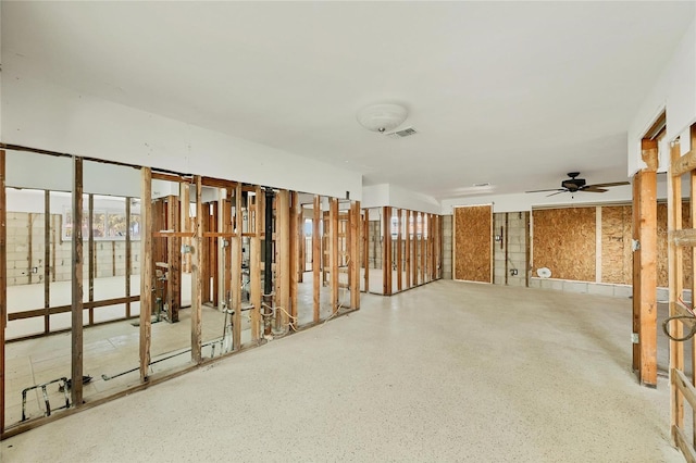 empty room with visible vents and speckled floor