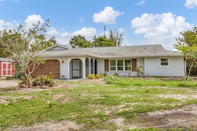 single story home featuring a front lawn and an attached garage