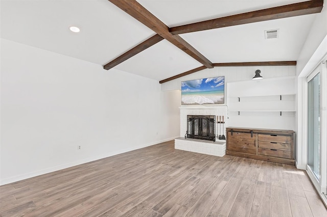 unfurnished living room with visible vents, baseboards, lofted ceiling with beams, light wood-type flooring, and a brick fireplace