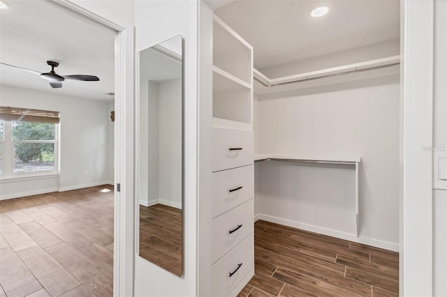 walk in closet with wood tiled floor and ceiling fan