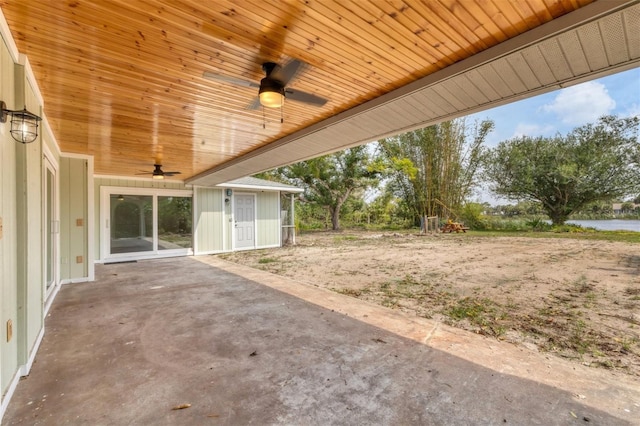 view of patio featuring ceiling fan and a water view