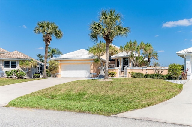 view of front of property featuring a garage, concrete driveway, a fenced front yard, a gate, and a front yard