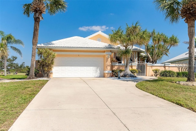 view of front facade featuring a garage, concrete driveway, a gate, fence, and stucco siding