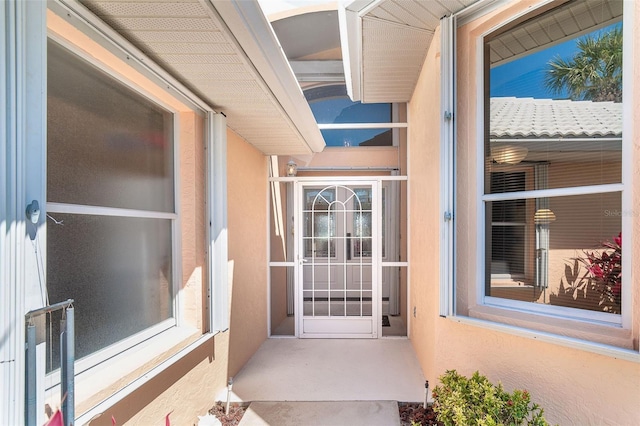 doorway to property with stucco siding