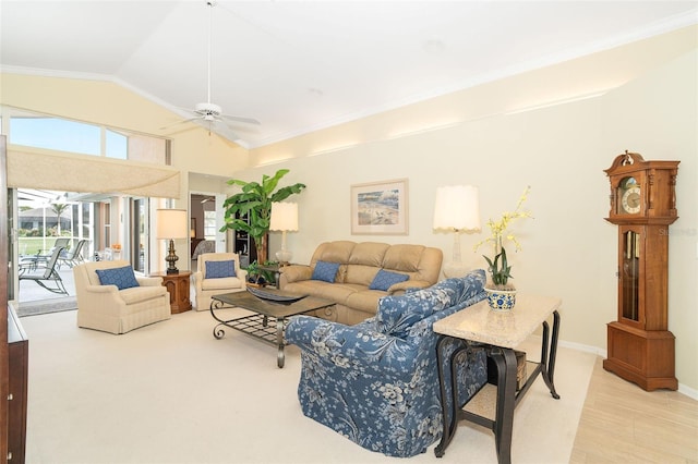 living area featuring crown molding, baseboards, vaulted ceiling, and a ceiling fan