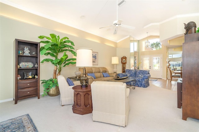 carpeted living room with ceiling fan, high vaulted ceiling, visible vents, french doors, and crown molding