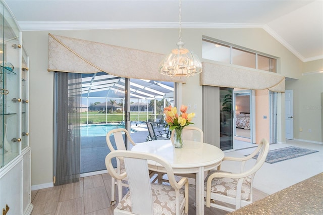 dining space featuring light wood-type flooring, a sunroom, ornamental molding, and vaulted ceiling