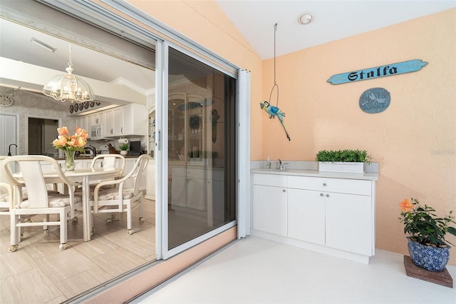 interior space featuring a patio, outdoor dining area, a sink, and visible vents