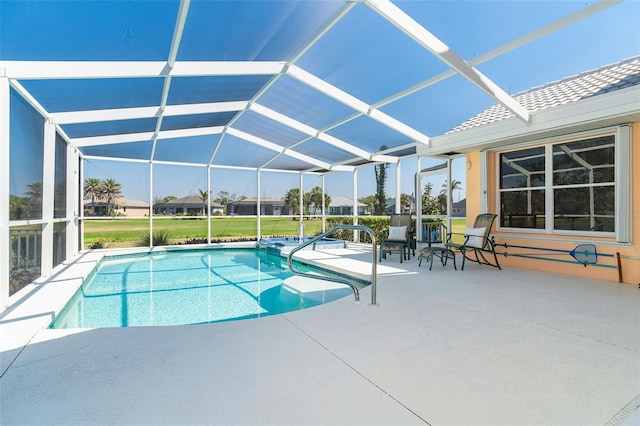 pool featuring glass enclosure and a patio