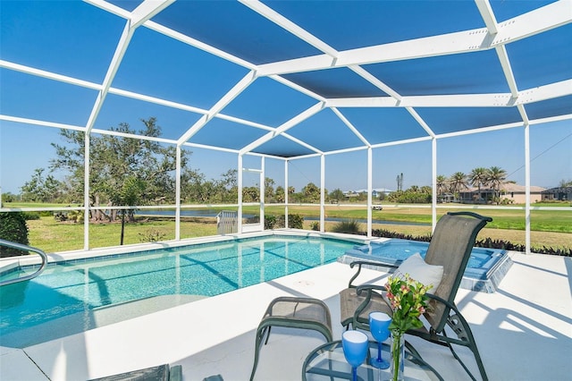 pool featuring a yard, glass enclosure, and a patio