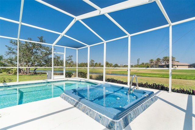 view of swimming pool featuring a patio, a yard, a lanai, and a pool with connected hot tub