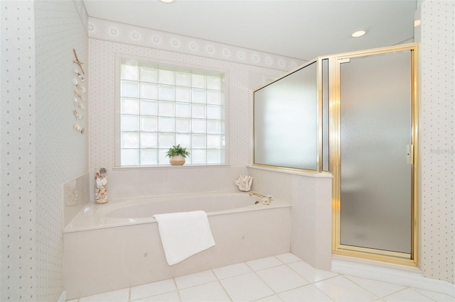 full bathroom featuring tile patterned flooring, a shower stall, a bath, and wallpapered walls