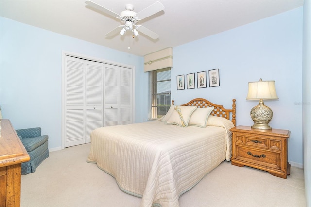 bedroom featuring a closet, light carpet, ceiling fan, and baseboards