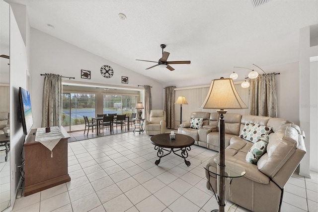 living area with lofted ceiling, a ceiling fan, and light tile patterned flooring