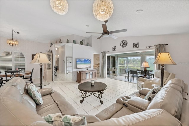 tiled living area featuring vaulted ceiling, a textured ceiling, and ceiling fan with notable chandelier