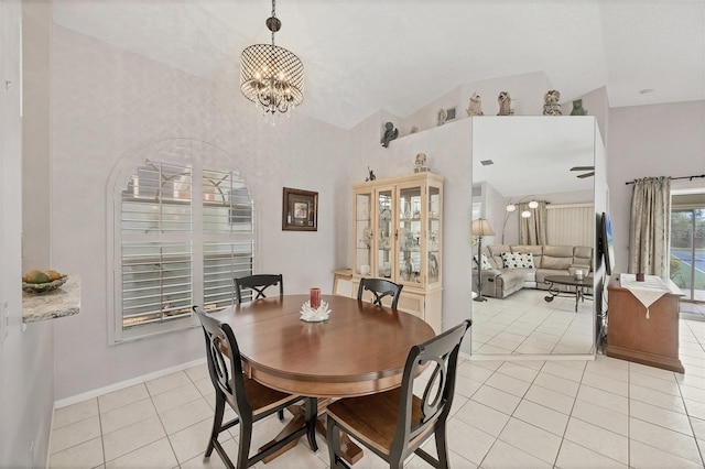 dining room featuring lofted ceiling, baseboards, an inviting chandelier, and light tile patterned floors