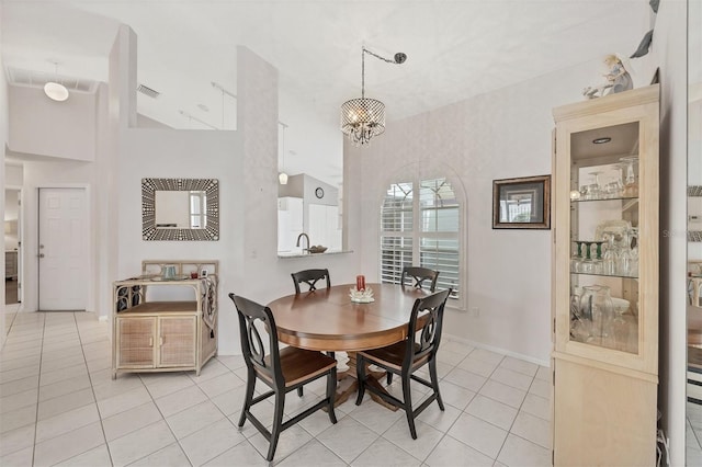 dining area featuring light tile patterned flooring, visible vents, baseboards, and an inviting chandelier