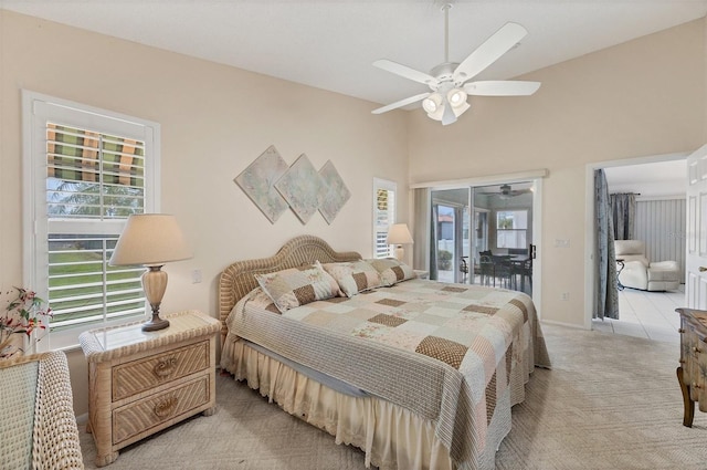 bedroom featuring light carpet, access to exterior, and a ceiling fan