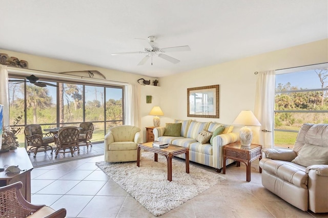 living area featuring light tile patterned floors, a ceiling fan, and a wealth of natural light