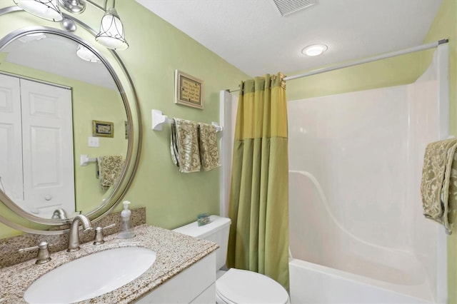 bathroom with vanity, shower / tub combo, toilet, and visible vents