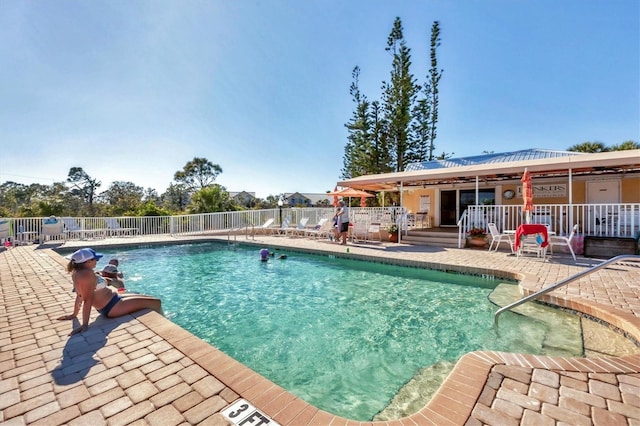 pool featuring a patio area and fence