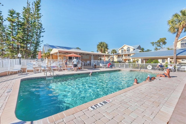 pool featuring a patio and fence