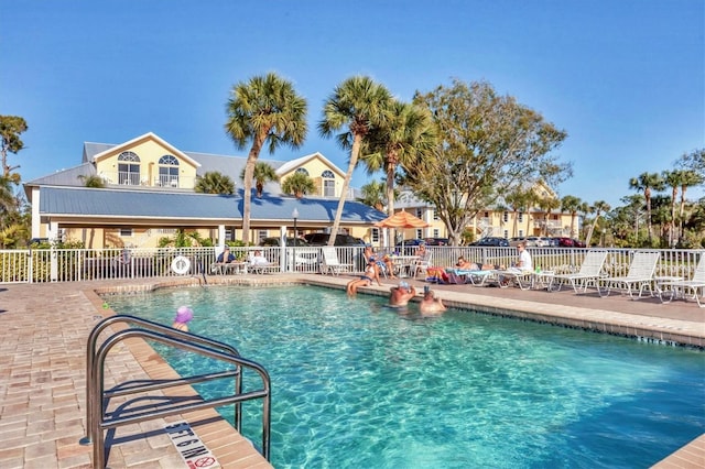 community pool featuring a patio area and fence