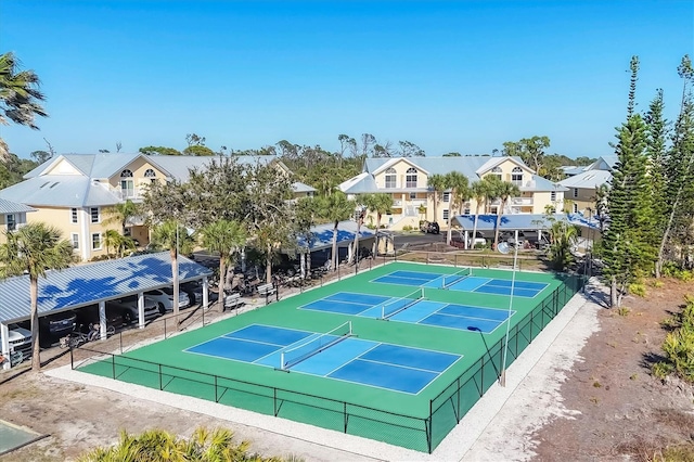 view of sport court featuring fence and a residential view