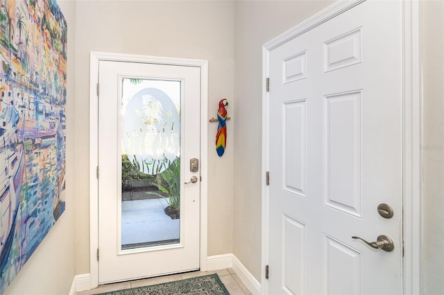 entryway featuring a healthy amount of sunlight, tile patterned flooring, and baseboards