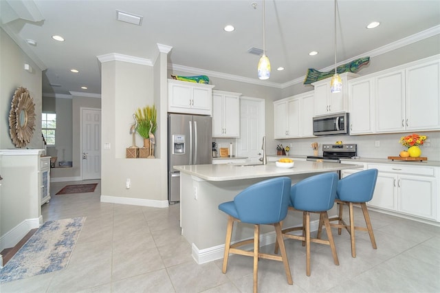 kitchen featuring light tile patterned flooring, stainless steel appliances, visible vents, ornamental molding, and tasteful backsplash